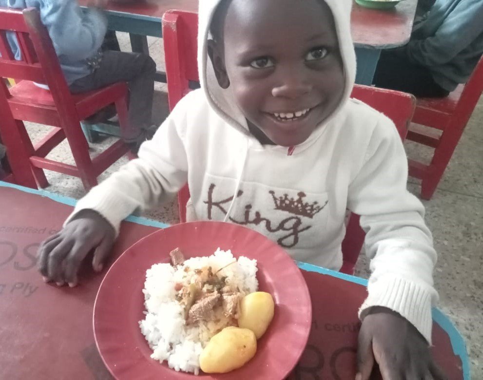 Community volunteers serving food and support packages to children in everyday clothes